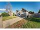 A gray home with an attached garage features a driveway and fenced-in yard at 16980 E Stanford Ave, Aurora, CO 80015