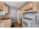 Practical kitchen featuring light wood cabinetry and essential appliances for everyday cooking at 16980 E Stanford Ave, Aurora, CO 80015