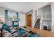 Bright living room with hardwood floors, comfortable seating, and plenty of natural light at 16980 E Stanford Ave, Aurora, CO 80015