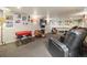 Spacious finished basement with ping pong table, tv, and unique football themed furniture at 6432 S Robb Ct, Littleton, CO 80127