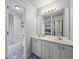 Bright bathroom featuring double sinks and a shower-tub combination at 6432 S Robb Ct, Littleton, CO 80127