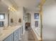 Bathroom featuring double sinks, soaking tub, and decorative touches at 6432 S Robb Ct, Littleton, CO 80127
