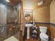 Bathroom featuring an updated shower, pedestal sink, and bronze fixtures at 6432 S Robb Ct, Littleton, CO 80127