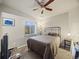 Bedroom with plush carpet, ceiling fan, and a bright window with a view at 6432 S Robb Ct, Littleton, CO 80127