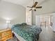 Spacious bedroom with vaulted ceiling, fan, wood floors, and ensuite bathroom at 6432 S Robb Ct, Littleton, CO 80127