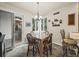 The dining area features a wooden table set, natural light, and easy access to the outdoor deck at 6432 S Robb Ct, Littleton, CO 80127