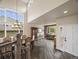 Open-concept dining area with large windows and hardwood flooring, with great natural light at 6432 S Robb Ct, Littleton, CO 80127