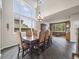 Spacious dining room with an elegant dining set and ample natural light through large windows at 6432 S Robb Ct, Littleton, CO 80127
