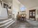 Elegant dining room with high ceilings, a large window, and stylish staircase at 6432 S Robb Ct, Littleton, CO 80127