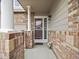 Inviting front entrance featuring brick accents and a secure storm door at 6432 S Robb Ct, Littleton, CO 80127