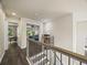 Bright hallway with wood floors leads to bedrooms, offering both charm and easy access at 6432 S Robb Ct, Littleton, CO 80127