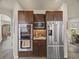 This spacious kitchen boasts dark wood cabinets, stainless steel appliances, and granite countertops at 6432 S Robb Ct, Littleton, CO 80127
