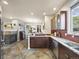 This open kitchen offers granite countertops, stainless appliances, and tile floors at 6432 S Robb Ct, Littleton, CO 80127
