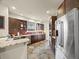 The spacious kitchen is equipped with stainless steel appliances, granite counters, and dark wood cabinetry at 6432 S Robb Ct, Littleton, CO 80127