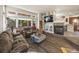 The inviting living room features plush seating, a fireplace, and large windows for natural light at 6432 S Robb Ct, Littleton, CO 80127
