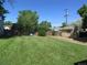 Expansive backyard with lush lawn, shed, and privacy fence, perfect for outdoor activities and relaxation at 1271 Xapary St, Aurora, CO 80011