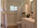 Well-lit bathroom featuring white subway tile shower, window, and vanity, combining classic style and functionality at 1271 Xapary St, Aurora, CO 80011