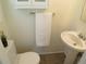 Cozy powder room with pedestal sink, toilet, and neutral walls creating a clean, functional space at 1271 Xapary St, Aurora, CO 80011