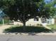 Charming single story house featuring mature shade tree, carport, and well-maintained front yard at 1271 Xapary St, Aurora, CO 80011