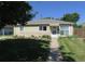 Charming single-story home with a well-manicured lawn and inviting walkway at 1271 Xapary St, Aurora, CO 80011