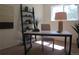 Bright home office with desk, chair, shelving unit, and natural light, creating a productive workspace at 1271 Xapary St, Aurora, CO 80011