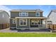 Spacious backyard with partial lawn, showcasing home's green exterior and porch area at 14912 Vienna Cir, Parker, CO 80134