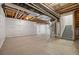 Partially finished basement with open ceiling, white-plastic-wrapped insulation, and stairs at 14912 Vienna Cir, Parker, CO 80134