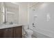 Tiled bathroom featuring a shower-tub combo and neutral vanity at 14912 Vienna Cir, Parker, CO 80134