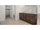 Bright bathroom featuring a double vanity with granite countertops and neutral tiled flooring at 14912 Vienna Cir, Parker, CO 80134