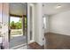 Inviting entryway featuring hardwood floors, a sidelight window, and an open view into a bright, airy room at 14912 Vienna Cir, Parker, CO 80134