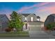 Charming two-story home featuring a spacious two-car garage and a well-manicured front lawn with a mature tree at 14912 Vienna Cir, Parker, CO 80134