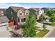 A high angle view shows a traditional home with a well manicured lawn and mature trees in a vibrant community at 14912 Vienna Cir, Parker, CO 80134