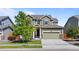 Inviting two-story home with a two-car garage, well-maintained lawn, and mature tree enhancing its curb appeal at 14912 Vienna Cir, Parker, CO 80134