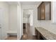 Hallway with wood floors, built-in bench, and convenient access to the kitchen at 14912 Vienna Cir, Parker, CO 80134