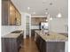 Modern kitchen featuring wood cabinets, stainless steel appliances, and granite countertops at 14912 Vienna Cir, Parker, CO 80134