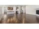 Spacious living area open to the kitchen featuring hardwood floors and a modern fireplace, perfect for entertaining at 14912 Vienna Cir, Parker, CO 80134