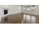 Open living room with hardwood floors, a modern fireplace, and large windows providing ample natural light at 14912 Vienna Cir, Parker, CO 80134