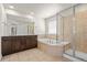 Luxurious bathroom with double vanity, soaking tub, and separate glass-enclosed shower at 14912 Vienna Cir, Parker, CO 80134