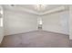Carpeted main bedroom with tray ceiling, bright lighting and en suite bathroom at 14912 Vienna Cir, Parker, CO 80134