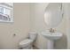 Powder room with pedestal sink, toilet, and neutral color palette at 14912 Vienna Cir, Parker, CO 80134