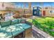 Green backyard with an outdoor sofa, a grill, a dining set, and shed structures on the lawn at 3109 N Williams St, Denver, CO 80205