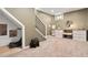 Finished basement with neutral carpet, black wrought iron stair railing, and study area with drawers at 3109 N Williams St, Denver, CO 80205