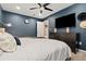 Comfortable bedroom with dark furniture and a large television at 3109 N Williams St, Denver, CO 80205