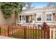 Inviting single-Gathering home with a cozy front porch and a quaint, wooden fence at 3109 N Williams St, Denver, CO 80205