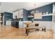 Eat-in kitchen features wooden table, designer lighting, and hardwood floors at 3109 N Williams St, Denver, CO 80205