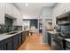 Stylish kitchen with herringbone backsplash, dark hardware, and wood floors at 3109 N Williams St, Denver, CO 80205