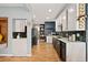 Modern kitchen showcasing sleek countertops, black appliances, and hardwood flooring throughout at 3109 N Williams St, Denver, CO 80205