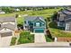 Aerial view of a two-story home with a manicured lawn, set against a scenic greenbelt backdrop at 3543 Foxridge Trl, Highlands Ranch, CO 80126