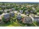 An aerial view showcasing houses nestled among lush green trees at 3543 Foxridge Trl, Highlands Ranch, CO 80126