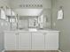 Bathroom featuring a double vanity, large mirror, and tiled floor at 3543 Foxridge Trl, Highlands Ranch, CO 80126